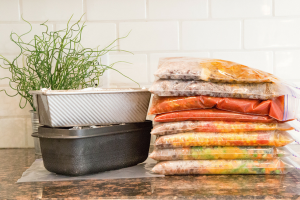 resealable bags stacked on counter top filled with freezer meals from myfreezeasy