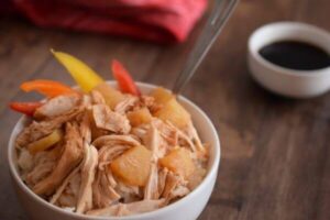 shredded chicken with red yellow and orange peppers in rice