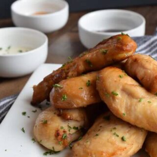 air fryer naked chicken tenders on a white plate